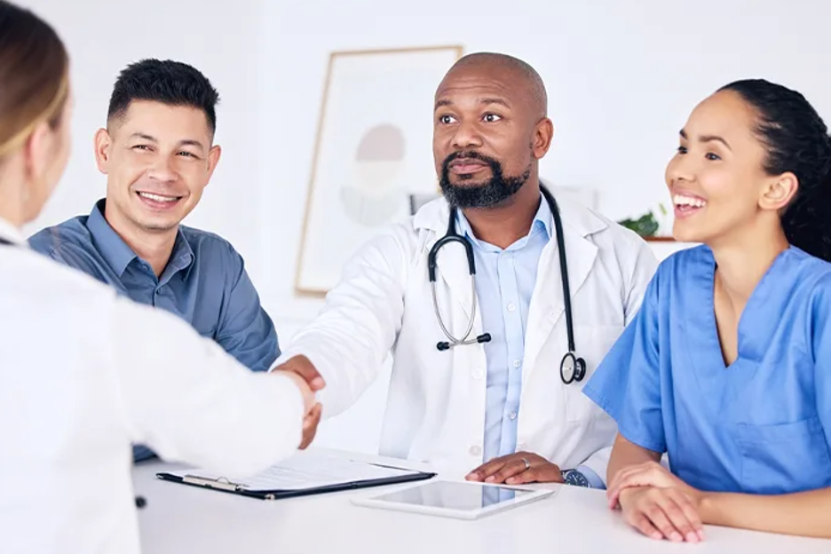 A group of diverse nurses talking and agreeing upon a deal.