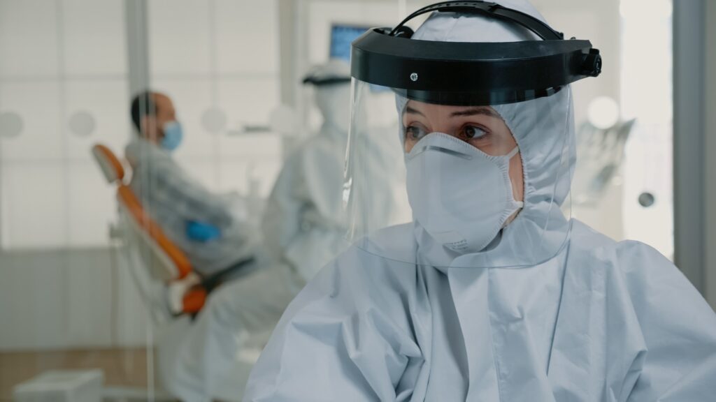 Close up of dentistry nurse with hazmat suit working on oral care