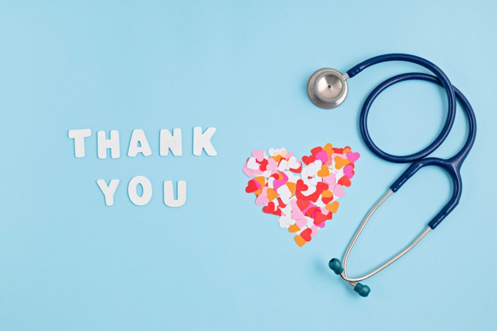 Hearts confetti and text thank you. Expressing gratitude to doctors and nurses
